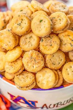 small crackers in a bowl with carrots next to them on a table top