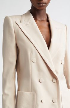 The silhouette-defining shoulders on this wool jacket exemplify the tailoring heritage that's a significant aspect of the Belgian designer's reputation. Sharply cut peaked lapels, precision topstitching and covered buttons on the double-breasted placket all contribute to the fitted, polished piece. 32" length (size 38 FR) Double-breasted button closure Peaked lapels Four-button cuffs Chest welt pocket; front patch pockets Lined 100% wool Dry clean Imported Designer Clothing Beige Wool Double-breasted Blazer, Luxury Beige Blazer With Suit Collar, Cream Wool Blazer For Business, Cream Notch Lapel Blazer With Double-breasted Buttons, Cream Notch Lapel Double-breasted Blazer, Timeless Beige Blazer With Lapel Collar, Elegant Beige Suit With Double Button Closure, Formal Cream Blazer With Double-breasted Button Fastening, Cream Double-breasted Blazer With Lapel Collar