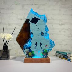 a glass sculpture with an image of a man and woman under the ocean on it