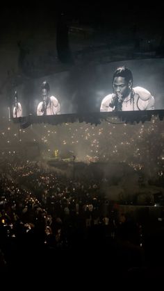 the stage is full of people and there are two large screens on each side of the screen