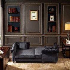 a living room filled with furniture and bookshelves next to a lamp on a table