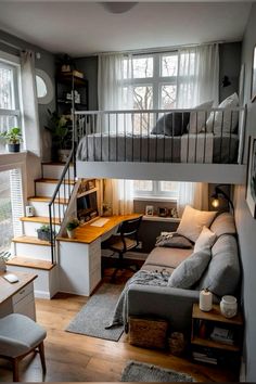 a loft bed with stairs leading up to the top floor and desk area below it