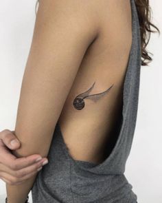 a woman with a small tattoo on her shoulder