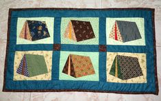 a quilted table runner with different ties on it