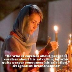 a woman holding candles in her hands with a quote from st ignius brahannovv