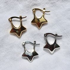 These star-shaped hoop earrings are made from silver/gold plated stainless steel and are safe for exposure to sweat and water without the threat of tarnishing.Length: ~0.75"Width: ~0.6" Star Hoop Earrings, Preppy Jewelry, Chunky Earrings, Dope Jewelry, Funky Jewelry, Jewelry Lookbook, Earrings In Gold, Jewelry Inspo, Dream Jewelry