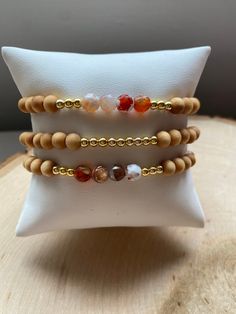 Our PUMPKIN SPICE stack! These are super stylish, comfortable and perfect for FALL! Such a trendy boho-look! (These are meant to fit snug. If you would like them to feel loose and move around on your wrist, please size up). Each bracelet is carefully handmade with high quality materials: -6mm natural Agate stones in Fall colors -6mm natural wood beads -3mm gold hematite beads -7mm black/gold acrylic letters -Cord: high-quality, durable, stretch cord with reinforced knots and specialty glue ⭐️⭐️W Handmade Agate Beaded Bracelets For Everyday, Everyday Handmade Agate Beaded Bracelets, Gold Bracelets With Wooden Beads For Healing, Earthy Wooden Beaded Bracelets For Gift, Earthy Wooden Beaded Bracelets As Gift, Handmade Natural Wood Beaded Bracelets, Handmade Adjustable Beaded Bracelets In Natural Wood, Handmade Adjustable Natural Wood Beaded Bracelets, Casual Gold Beaded Bracelets With Gemstone