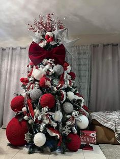 a christmas tree decorated with red, white and silver ornaments