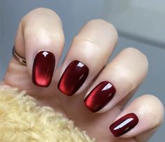 a woman's hand with red nail polish on it