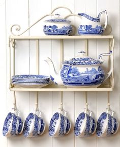 blue and white china is hanging on the wall