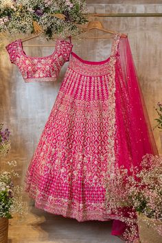 The Nazia lehenga features a bright pink lehenga that is hand-embroidered with fine glass beads, pearls, and thread. It is paired with a matching blouse and dupatta.by Chamee and Palak. DELIVERY TIMEPlease allow 8-12 weeks for your outfit to arrive. FABRIC DETAILSRaw silk, Net. Pink Sharara With Dori Work For Reception, Traditional Pink Anarkali Set For Reception, Pink Dola Silk Designer Sets, Designer Pink Dola Silk Sets, Pink Anarkali Choli With Zari Work, Designer Pink Sharara With Dori Work, Pink Dress With Dori Work For Designer Wear, Pink Bollywood Choli With Dori Work, Pink Chandbali Set With Mirror Work