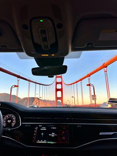 the view from inside a car looking at the golden gate bridge