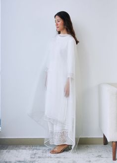 Effortless elegance in classic white. Our set features a georgette kurta with beaded organza panels, accompanied by a matching beaded organza dupatta delicately finished with lace trim. This ensemble evokes a sense of timeless calm and ease, making it a perfect choice for any occasion. White Palazzo Set With Sheer Dupatta And Straight Kurta, White Kurta With Sheer Dupatta In Traditional Drape, White Kurta With Sheer Dupatta, Festive Straight Kurta With Lace Trim, Elegant White Palazzo Set For Wedding, White Anarkali Palazzo Set With Sheer Dupatta, Elegant White Palazzo Set With Chikankari Embroidery, Sheer Organza Sets For Eid, Elegant Sheer Sets For Festive Occasions