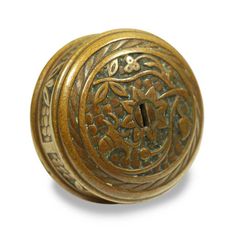 an antique brass door knob with floral designs on it's side and a key hole in the middle