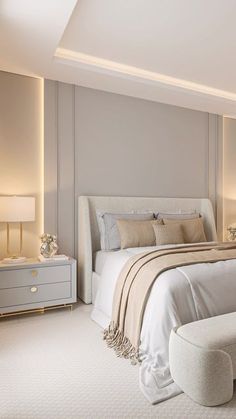 a large white bed sitting in a bedroom next to two nightstands with lamps on them