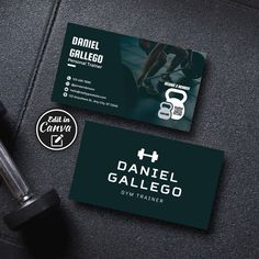 two business cards for a personal training center with dumbbells and barbells