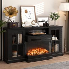 a living room with a fire place in the center and pictures on the wall next to it