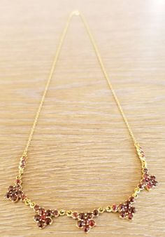 "This is an antique garnet and gold flower necklace. It is marked \"333\" on the closure for 8k gold. This piece is in excellent vintage condition. This necklace measures 17 inches." Gold Garnet Necklace For Wedding, Victorian Garnet Necklace, Victorian Garnet Necklace For Gift, Victorian Garnet Necklace Gift, Gold Garnet Birthstone Necklace, Formal Yellow Gold Garnet Necklaces, Formal Yellow Gold Garnet Necklace, Vintage Garnet Gemstone Necklace, Victorian Brown Necklace For Gift