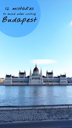 a large white building sitting next to a body of water