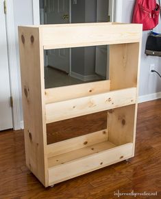 a wooden shelf sitting on top of a hard wood floor