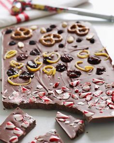 chocolate barkle with candy canes and pretzels on top, surrounded by candies