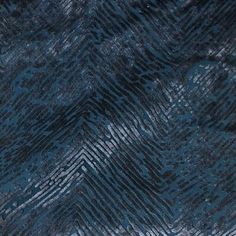 an up - close shot of the fabric in blue and grey tones, with wavy lines on it