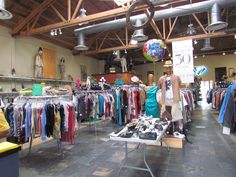 the inside of a clothing store with clothes on display