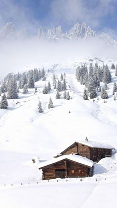 a cabin in the middle of a snow covered mountain