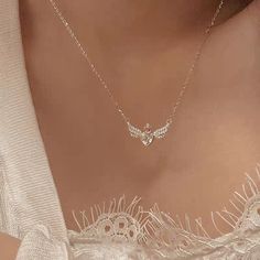 Description:Crown Heart Angel Wings Necklace Specifications:Material: crystal, cubic zirconia, copper, 18k silverColors: silverSize: 40 cm + 5 cm extWeight: 3.8 g/pcs Feel like royalty with our Crown Heart Angel Wings Necklace! This beautiful necklace features a stunning crown design, enhanced by delicate angel wings. Perfect for those with a touch of whimsy and a love for all things elegant. Make a statement with this unique and playful accessory. ✨ Angelic Jewelry, Angel Wings Necklace, Angel Wings Design, Angel Wings Heart, Wings Necklace, Angel Wing Necklace, Crystal Angels, Heart With Wings, Dress Indian