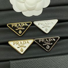 Prada Brooch - Iconic Luxury Accessory - prada brooch pin - - Inspire Uplift Elegant Formal Jewelry With Logo Plaque, Luxury Gold Enamel Pin For Formal Occasions, Luxury Formal Enamel Pin, Luxury Silver Brooches, Luxury Silver Lapel Pin As Gift, Luxury White Brooches As Gift, Luxury White Brooch For Gift, Luxury White Brooches For Gifts, Designer White Brooches For Formal Occasions