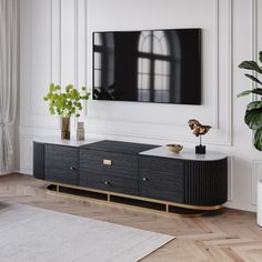 a living room with white walls and black furniture