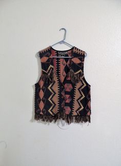 "Vintage Agapo Collection Southwest Vest with Fringe, Made in India. In great vintage condition with little wear. Made of a thick woven cotton. Tag says size small, but please check dimensions below as it seems it may be small to medium in my opinion. Approx. dimensions lying flat are. Shoulder to bottom of fringe 25\" Chest 19\" Fringe 3\" Three wood button closure. A unisex vest in Hippy, Boho, Southwestern, Cowboy, Native American style, depending on how you accessorize." Vintage Brown Cotton Vest, Vintage Festival Vest, Tassel Vest, Native American Style, Star Shoes, Native American Fashion, Vest Outfits, Style And Grace, Woven Cotton