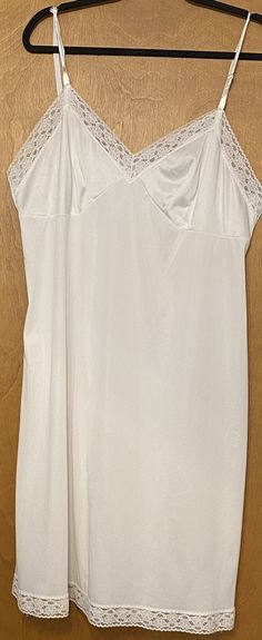 Vintage Vanity Fair made in USA full slip size 42 (XL) Nylon with lace trim 19" underarm to underarm  44" waist 42" overall length White Bias Cut Slip Dress For Wedding Night, Lace Camisole Slip Dress Bias Cut, Lace Camisole Slip Dress With Lace Bodice, White Sleeveless Slip Dress With Bias Cut, White Slip Dress With Spaghetti Straps And Bias Cut, White Sheer Camisole Dress, Fitted White Lace Nightgown, White Bias Cut Slip Dress For Sleep, White Lace Fitted Nightgown