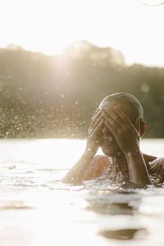 a person in the water covering their face