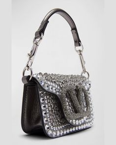 Valentino Garavani "Loco" shoulder bag in allover embellished leather     Detachable top handle     Detachable chain shoulder strap    Can be worn as a top handle or shoulder bag     Flap top with VLOGO magnetic closure     Approx. 2.8"H x 5.1"W x 1.8"D    Made in Italy Glamorous Bags With Silver-tone Hardware And Top Handle, Glamorous Top Handle Bag With Silver-tone Hardware, Luxury Crossbody Evening Bag For Events, Luxury Leather Shoulder Bag For Events, Luxury Handheld Evening Bag, Luxury Shoulder Bag With Silver-tone Hardware And Top Handle, Evening Shoulder Bag With Silver-tone Hardware And Top Handle, Luxury Top Handle Shoulder Bag With Silver-tone Hardware, Designer Evening Clutch With Silver-tone Hardware