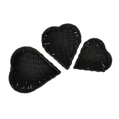 three pieces of black knitted heart shapes