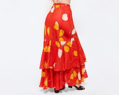 Vintage 70s bright red linen maxi skirt with a statement white & yellow tulip print, and ruffled lower tiers. There is a metal side zipper and two hooks for closure. Super flattering fit that hugs your curves! Measurements and Condition: Fits like: Women's small Fabric: Feels like linen, sheer Brand: None Condition: Excellent Length: 41" Waist: 26.5" Hips: approximately 38" (has some give due to the cut of the fabric, can fit larger) Shown on a 5'8" model with measurements of 35"-26"-38", usually wears a size small to medium. See our FAQ for more info on sizing and condition ratings. Linen Maxi Skirt, Print Maxi Skirt, Tulip Print, Yellow Tulips, Printed Maxi Skirts, Tier Skirt, Tiered Skirt, Printed Maxi, Bright Red