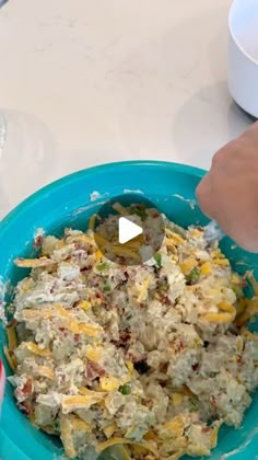 a person is mixing food in a bowl