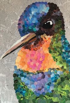 a colorful bird made out of buttons on a piece of paper with scissors in its beak