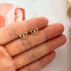 Be bold and beautiful with our small CZ butterfly stud earrings! Perfect for women who want to add a touch of elegance to their everyday look. These delicate studs feature sparkling CZ stones and a charming butterfly design. Elevate your style effortlessly with our stunning earrings. Surprise her with these stunning earrings! The perfect gift for any woman, these earrings will add elegance and beauty to any outfit. Treat your loved one to something special with these earrings. Earrings size about 0.4 inch. Small Butterfly Earrings Gold, Butterfly Small Earrings, Dainty Tiny Butterfly Earrings, Gold Butterfly Earrings Studs, Gold-plated Butterfly Earrings, Butterfly Stud Earrings, Butterfly Earrings Stud, Earring Gold, Earrings Women