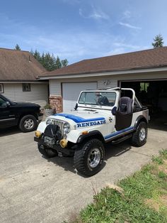 a jeep parked in front of a garage