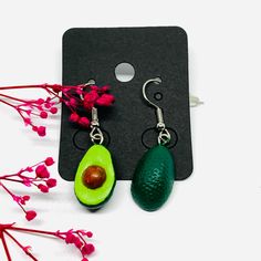 Inspired by the vibrant culture and art of Mexico, these Avocado Clay Earrings are a must-have for any fashion-forward individual. Hand-crafted by skilled artisans, each intricate design showcases the beauty of traditional Mexican jewels. Indulge in the delicious combination of mini realistic drops and dangle earrings that radiate natural charm and elegance. Perfect for summer fashion, these earrings are a unique and memorable gift that will be cherished and worn with pride. Gift-ready, these ea Green Hoop Earrings For Festivals And Gifts, Multicolor Single Earring Jewelry Gift, Multicolor Single Earring As Gift, Artistic Single Earring For Gift, Handmade Green Plug Earrings As Gift, Green Teardrop Earrings As Gift, Green Teardrop Earrings For Gift, Green Teardrop Clip-on Earrings For Gift, Green Pierced Hoop Earrings For Gift