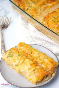 an omelet on a plate next to a glass casserole dish with a fork