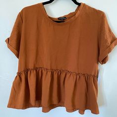 New With Tags Originality Adobe Ruffle Trim Blouse Women's Size Large. Listing No 375-8. Measurements Are Approximate, Oversized Fit, No Stretch Shoulders 36" Chest 42" Waist 42" Length 21" Chic Brown Tops For Daywear, Peplum Blouse With Ruffles For Work, Summer Workwear Peplum Blouse, Casual Short Sleeve Blouse With Ruffle Hem, Casual Ruffle Hem Top For Brunch, Brown Spring Tops For Daywear, Casual Fall Peplum Top For Brunch, Brown Tops For Spring Daywear, Brown Tops For Daywear In Spring