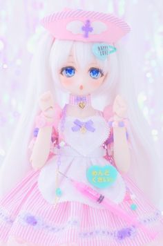 a doll is wearing a pink dress and holding a heart shaped object in her hand