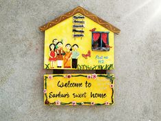 a welcome sign to someone's sweet home on the side of a building that is painted yellow