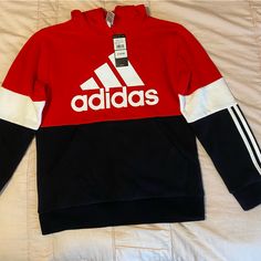 Size 14/16 Brand New Front Pocket And Hood Stripes Down The Sleeves Red Adidas Tops For Winter, Adidas Winter Hoodie With Letter Print, Winter Sportswear Hoodie With Color Block, Adidas Red Winter Tops, Adidas Red Sweatshirt For Winter, Adidas Long Sleeve Hoodie With Letter Print, Black Fleece Hoodie With Color Block, Adidas Cotton Hoodie With Letter Print, Red Adidas Sweatshirt For Winter