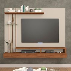 a flat screen tv sitting on top of a wooden shelf