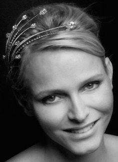 a woman wearing a tiara smiling at the camera