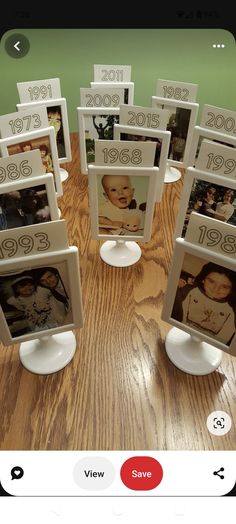 a group of framed pictures sitting on top of a wooden table next to each other